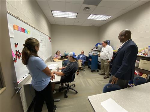 Board members Travis Cummings and Gregg Hulsey with Supt. Nichols observing a math tutoring session at James Clemens HS